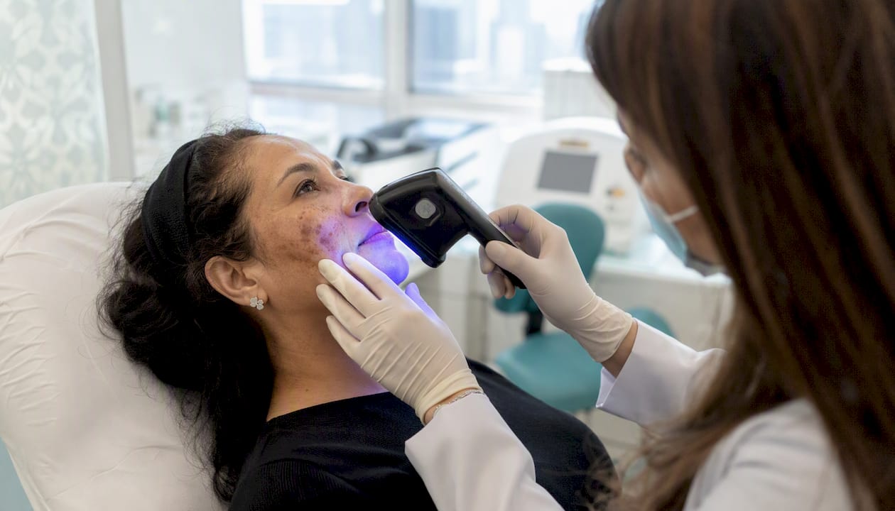Dermatologist inspecting skin pigmentation