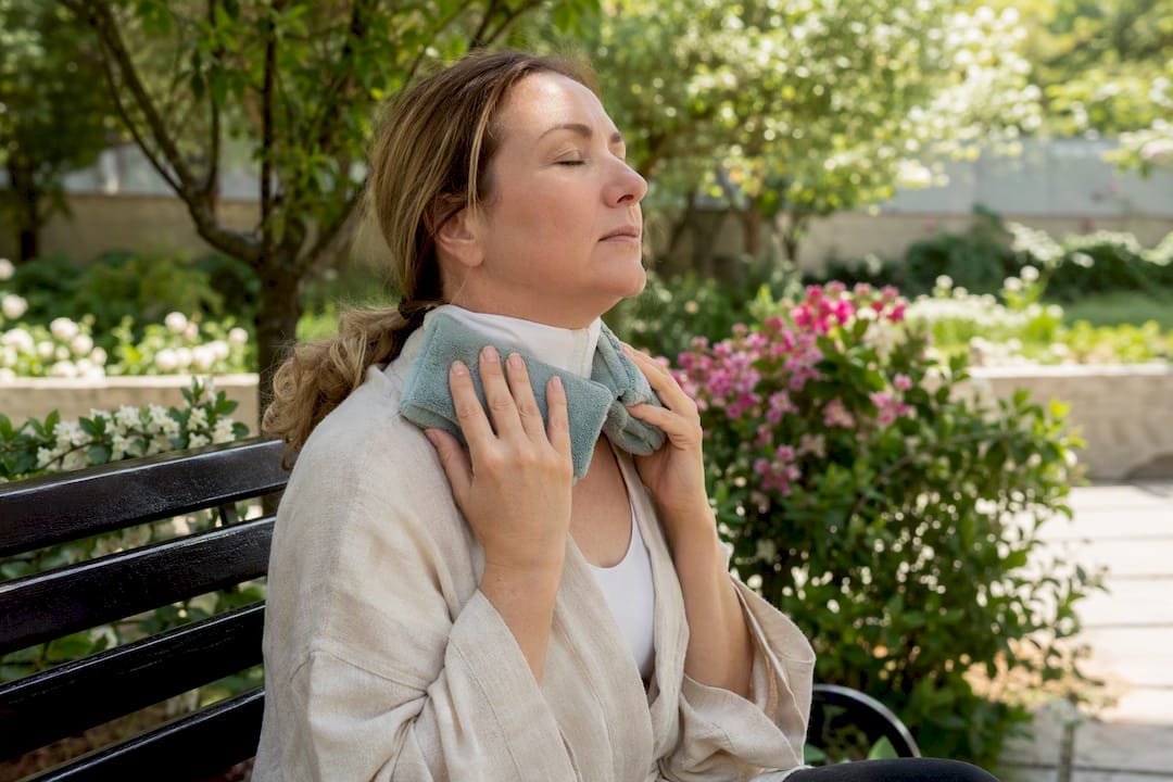 Patient applying ice packs after neck lift surgery